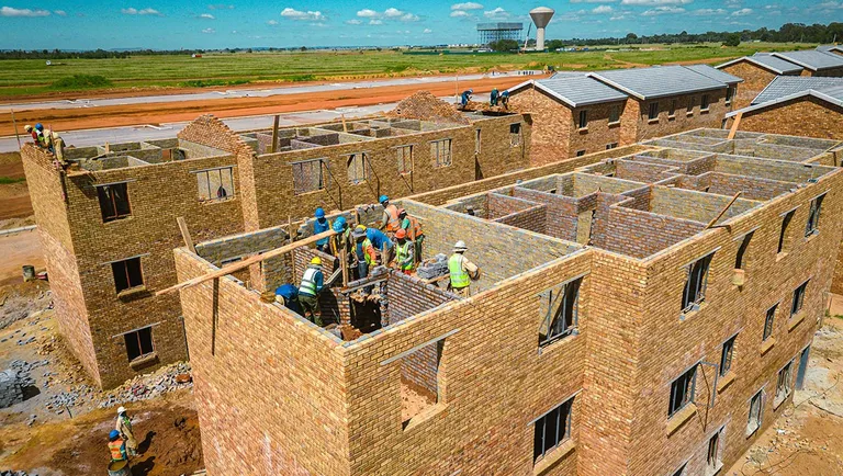 Bricklayers building two-storey face-brick units at Affri-Village Droogeheuwel